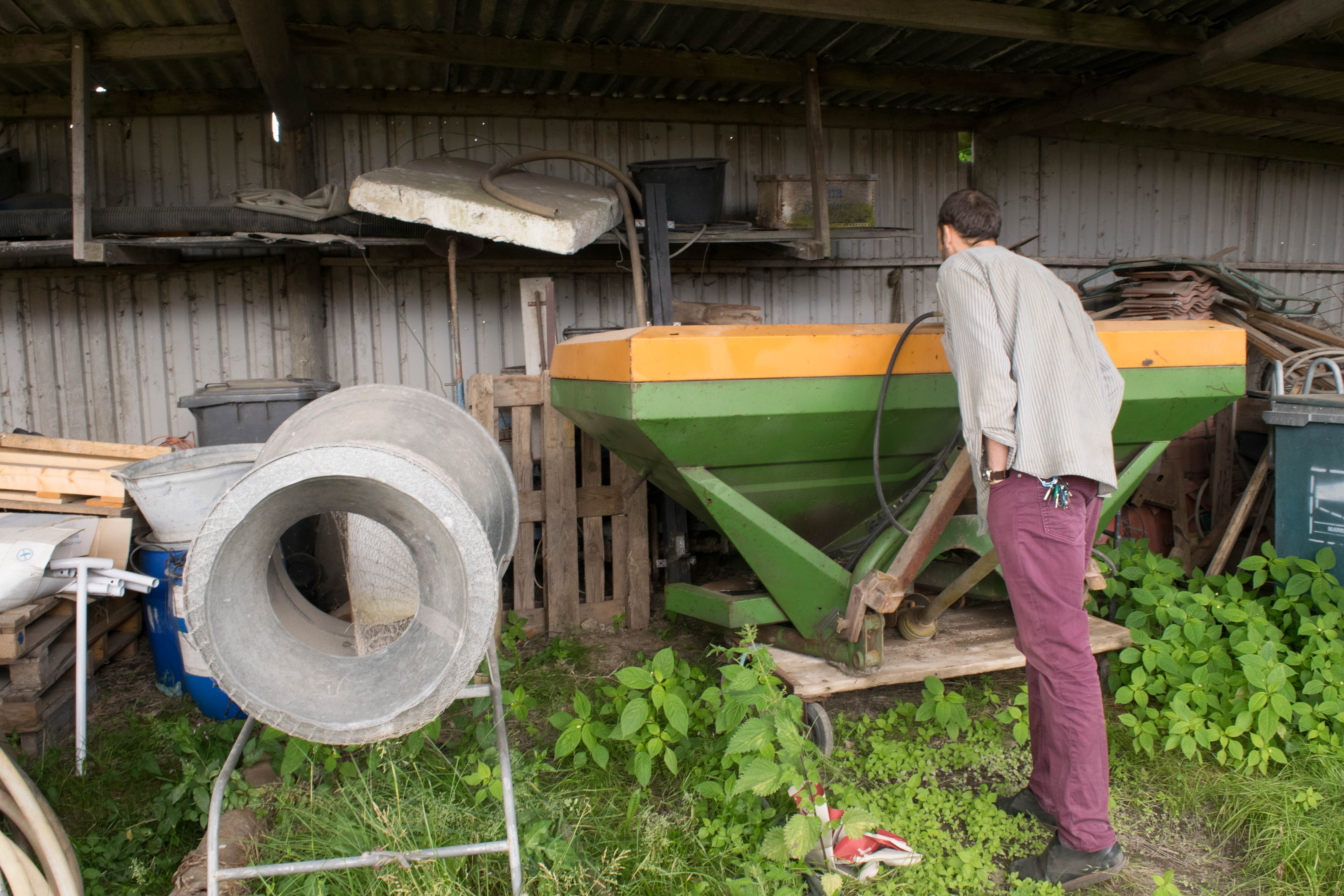 me looking at a large mechanical fertilizer at Paul's farm
